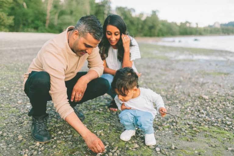 parent with child looking at stones