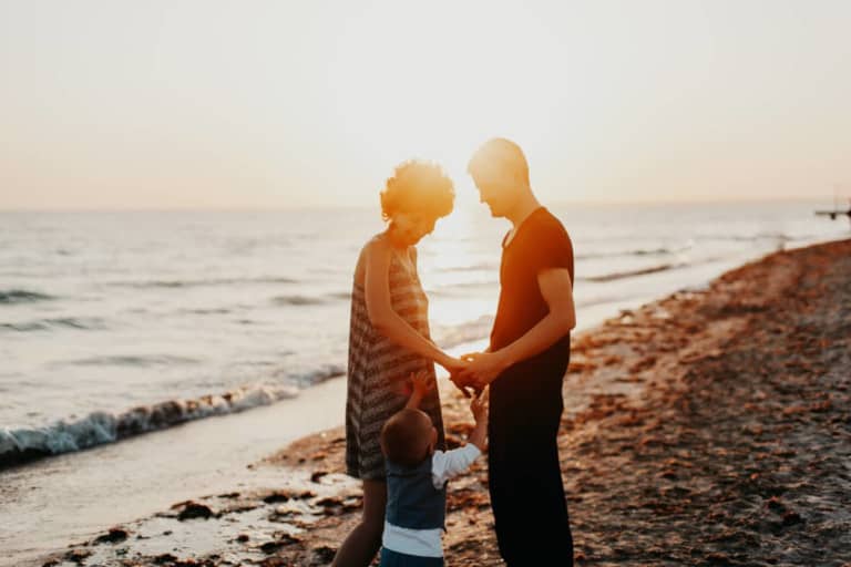 parents with child at beach