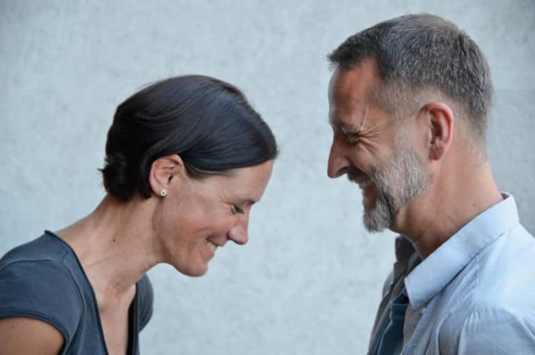 man and woman smiling together