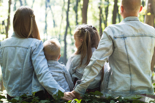 family with parents holding hands